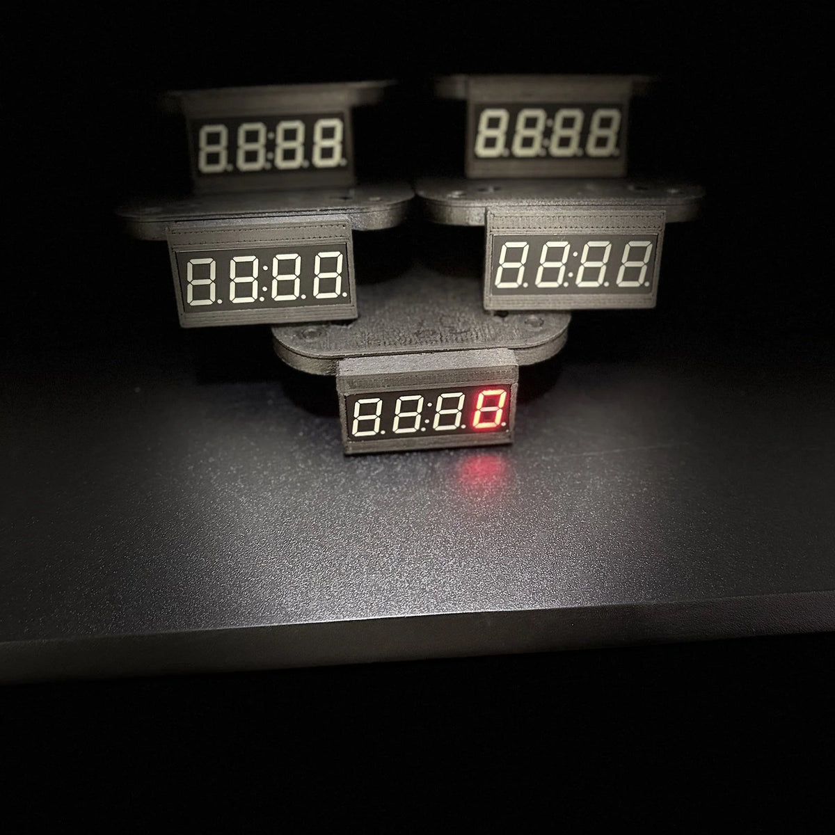 Five LED Edition counters on their mounts, screens lit