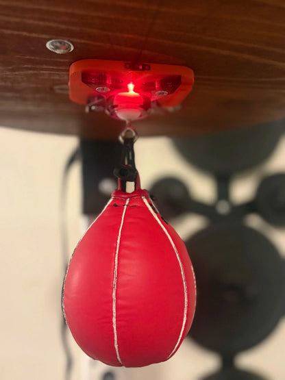 The Speedbag Champ counter under a platform, glowing red as it counts a red speed bag