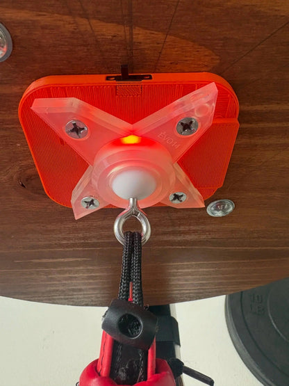 The orange Speedbag Champ counter screwed to the underside of a platform, with the EVO14 swivel mounted below it