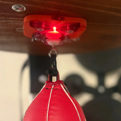 The Speedbag Champ counter under a platform, glowing red as it counts a red speed bag