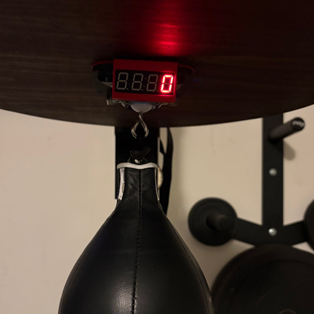Close-up of the Speedbag Champ LED screen lit under the platform, above the swivel and speed bag